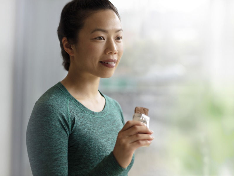 Woman eating a nutrition bar