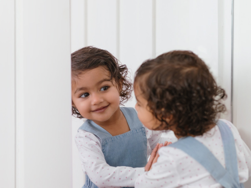 Child looking in mirror