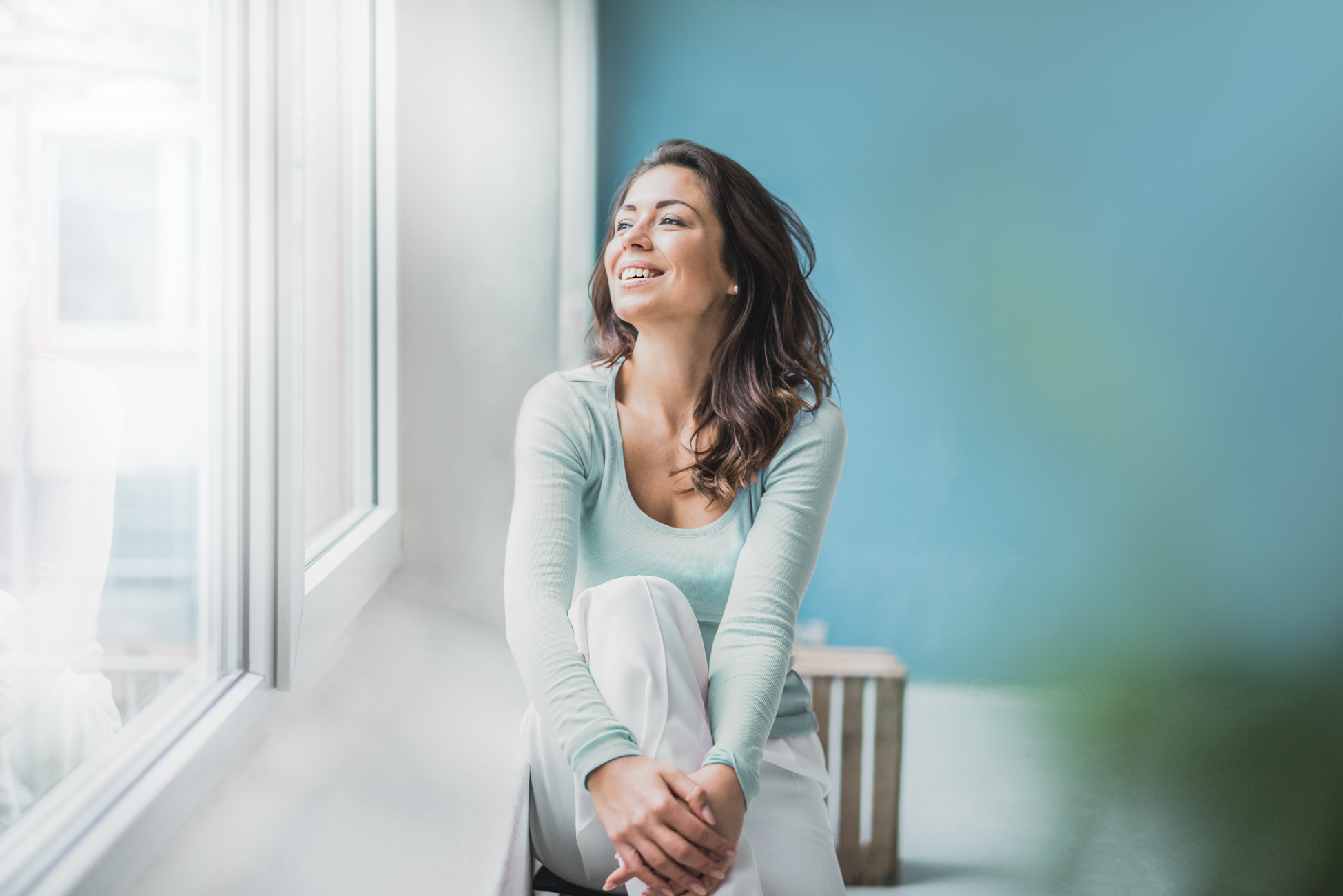 Woman sitting and looking out of the window