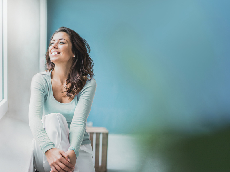 Woman sitting and looking out the window
